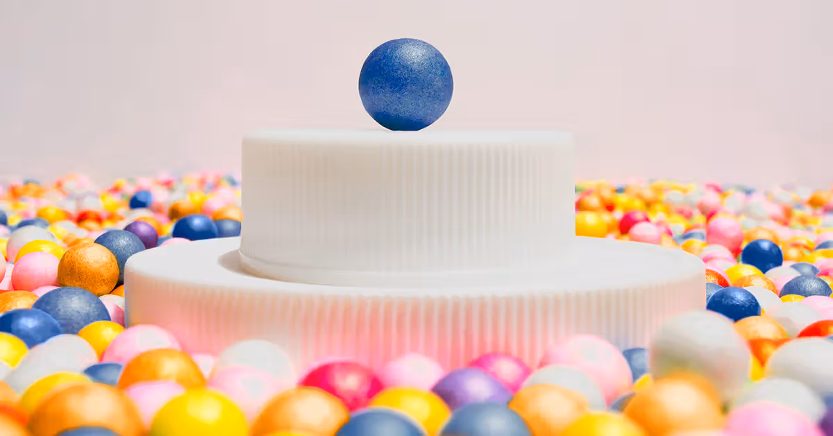 blue-ball-on-pedestal-surrounded-by-multi-colored-balls-1200×628-facebook-1200×628